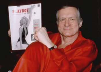 Hugh Hefner relaxes in red satin pajamas with the first copy of Playboy magazine in his Holmby Hills estate in Los Angeles recently. Hefner turns 70-years-old Tuesday, April 9, 1996.  The first magazine in 1953 featured a nude Marilyn Monroe. (AP Photo/Playboy, Elayne Lodge)