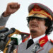 FILE - In this Saturday, June 12, 2010 file photo, Libyan leader Moammar Gadhafi talks during a ceremony to mark the 40th anniversary of the evacuation of the American military bases in the country, in Tripoli, Libya. The Associated Press is aware of reports that Moammar Gadhafi has been captured in Sirte. The chief spokesman for the revolutionary National Transitional Council Jalal el-Gallal and the council military spokesman Abdul-Rahman Busin told the AP that those reports are unconfirmed. (AP Photo/ Abdel Magid Al Fergany, File)