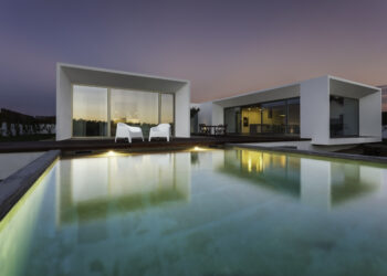 Modern house with garden swimming pool and wooden deck