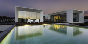 Modern house with garden swimming pool and wooden deck